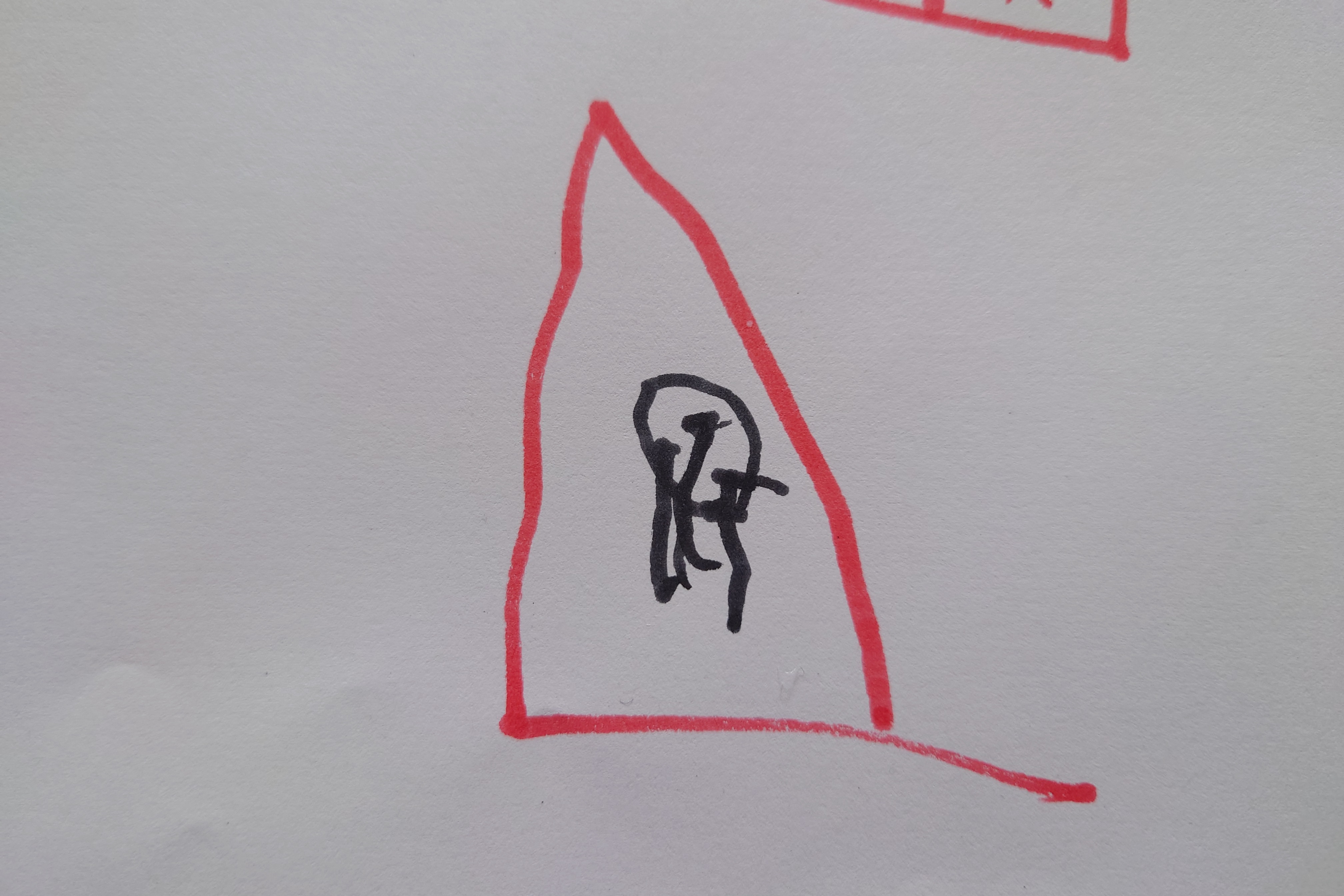A kids drawing of a red triangle warning sign with a black octopus icon on it